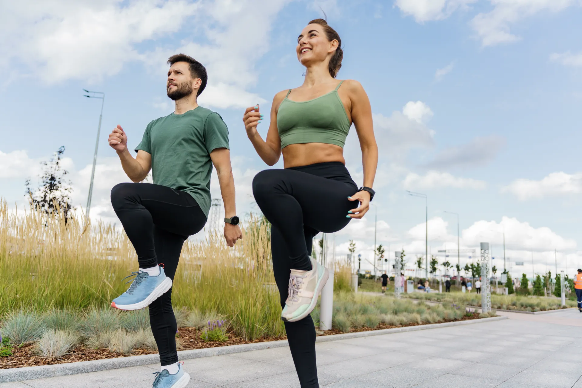 couple exercising in urban park on a sunny day utc